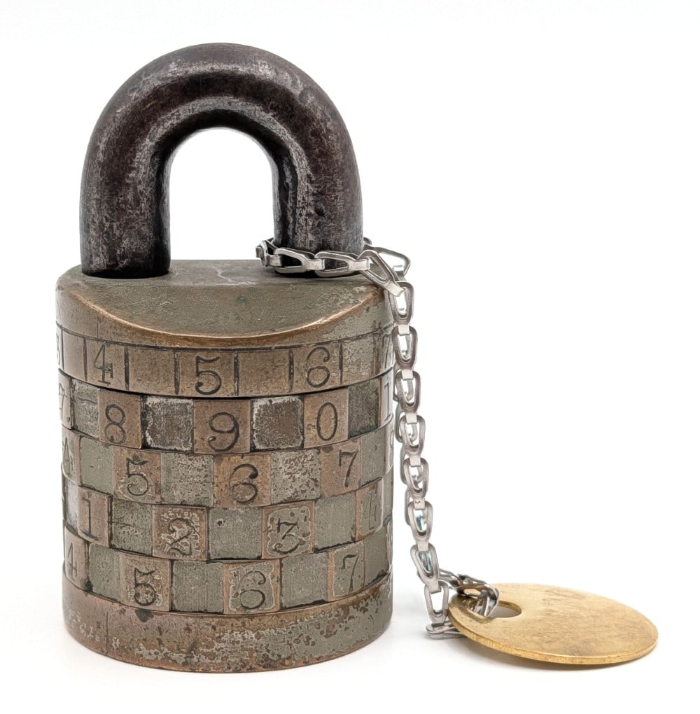 Antique Combination Code Padlock: Antique combination code padlock with combination. The padlock is marked on the bottom, but it is illegible. Measures approximately 2-3/4" tall.