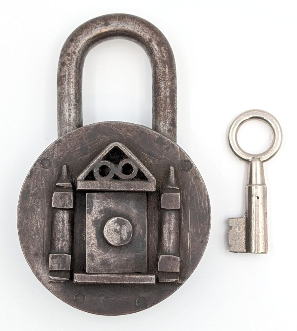 Antique Padlock w/ Castle Gate: Antique padlock with castle door. The padlock comes with the key and works. Shows wear from use and age. Measures approximately 4" long.