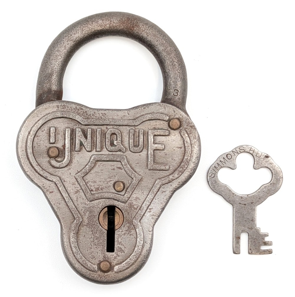 Early Unique Padlock: Early "Unique" padlock with key. The padlock shows wear from use and age. Measures approximately 3-1/2" long.