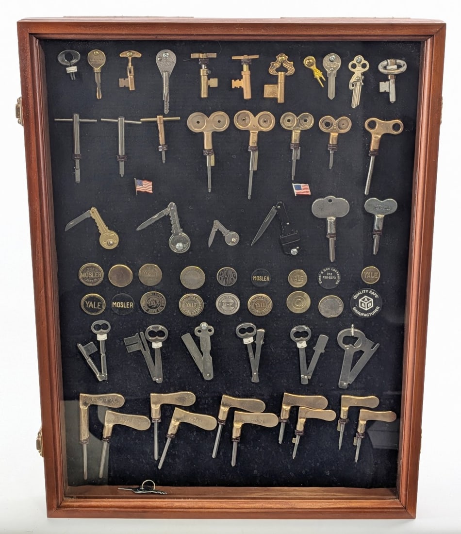 Antique Key Shadowbox Display: Display includes safe combination change keys, folding keys, lock badges, and other unique pieces. Display measures 18in x 24in.