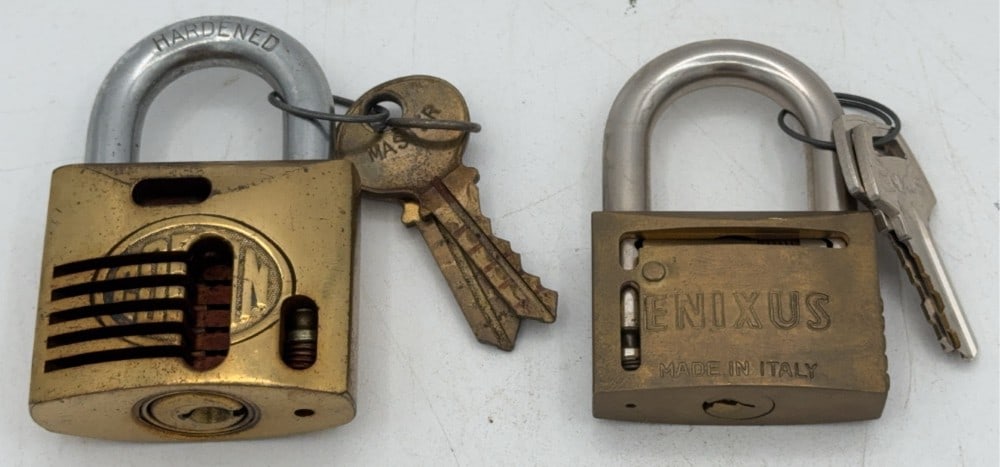 Corbin & Enixus Cut Away Padlock Salesman Samples: Locks are in good condition with scuffs and wear from age and handling. Both locks come with the keys. Largest measures 2-7/8in long.