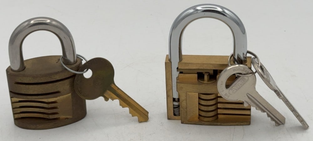 Abus & Unknown Brand Cut Away Padlock Salesman Samples: Locks are in good condition with scuffs and wear from age and handling. Both locks come with the keys. Largest measures 3in long.