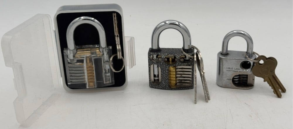 Eagle, Blossom, & Acrylic Cut Away Padlock Salesman Samples: Locks are in good condition with scuffs and wear from age and handling. Both locks come with the keys. Largest measures 3-1/8in long.