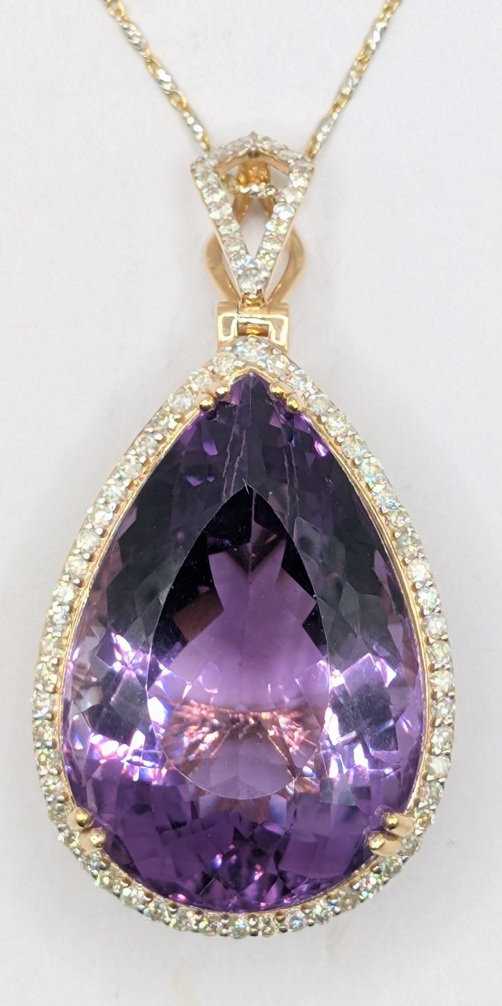 14K Gold Amethyst & Diamond Pendant Necklace: 14K yellow gold pendant with 51.32 CT purple amethyst quartz and (74) round brilliant cut diamonds totaling 0.85 CTS. Pendant is on 18" gold chain and the total weight is 17.9 grams. Necklace comes wi