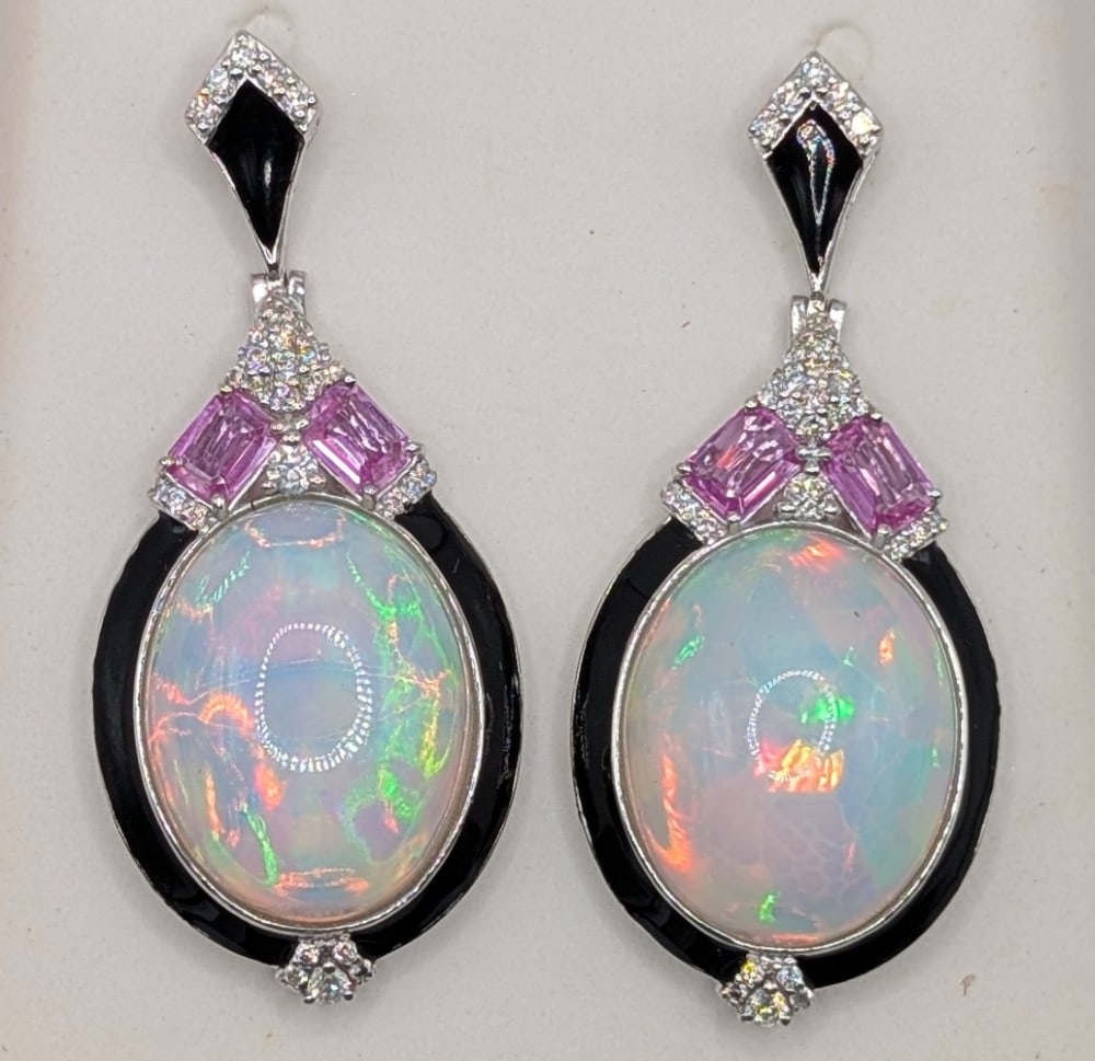 Platinum Opal Sapphire & Diamond Drop Earrings: Platinum drop earrings with (2) oval cabochon opal totaling 24.65 CTS, (4) link sapphires totaling 1.45 CTS and (58) round cut diamonds totaling 0.55 CTS. Earrings weigh 21.3 grams. Earrings come with