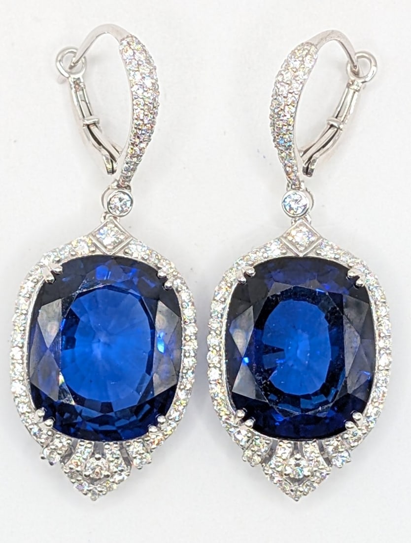 14K Gold Sapphire & Diamond Drop Earrings: 14K white gold drop earrings with (2) cushion cut lab created blue sapphires totaling 44.39 CTS and (168) round cut diamonds totaling 1.94 CTS. Earrings weigh 15.6 grams. Earrings come with a Gemassur