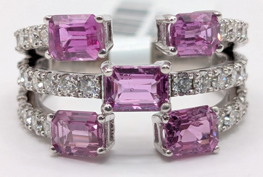 14K Gold Pink Sapphire & Diamond Ring: 14K white gold ring with (5) octagonal cut pink Sapphire totaling 2.92 CTS and (40) round cut diamonds totaling 1.17 CTS. Ring is size 7.5 and weighs 6.7 grams. Ring comes with a Gemassure gemological