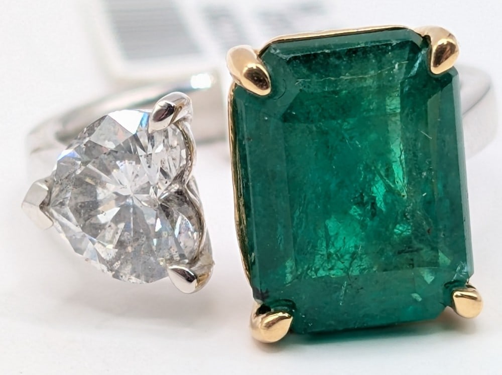 18K Gold Emerald & Diamond Ring: 18K yellow and white gold ring with 5.89 CT dark green emerald and 1.30 CT heart brilliant cut diamond. The ring is size 7 and weighs 6.4 grams. Ring comes with a Gemassure gemological appraisal repor