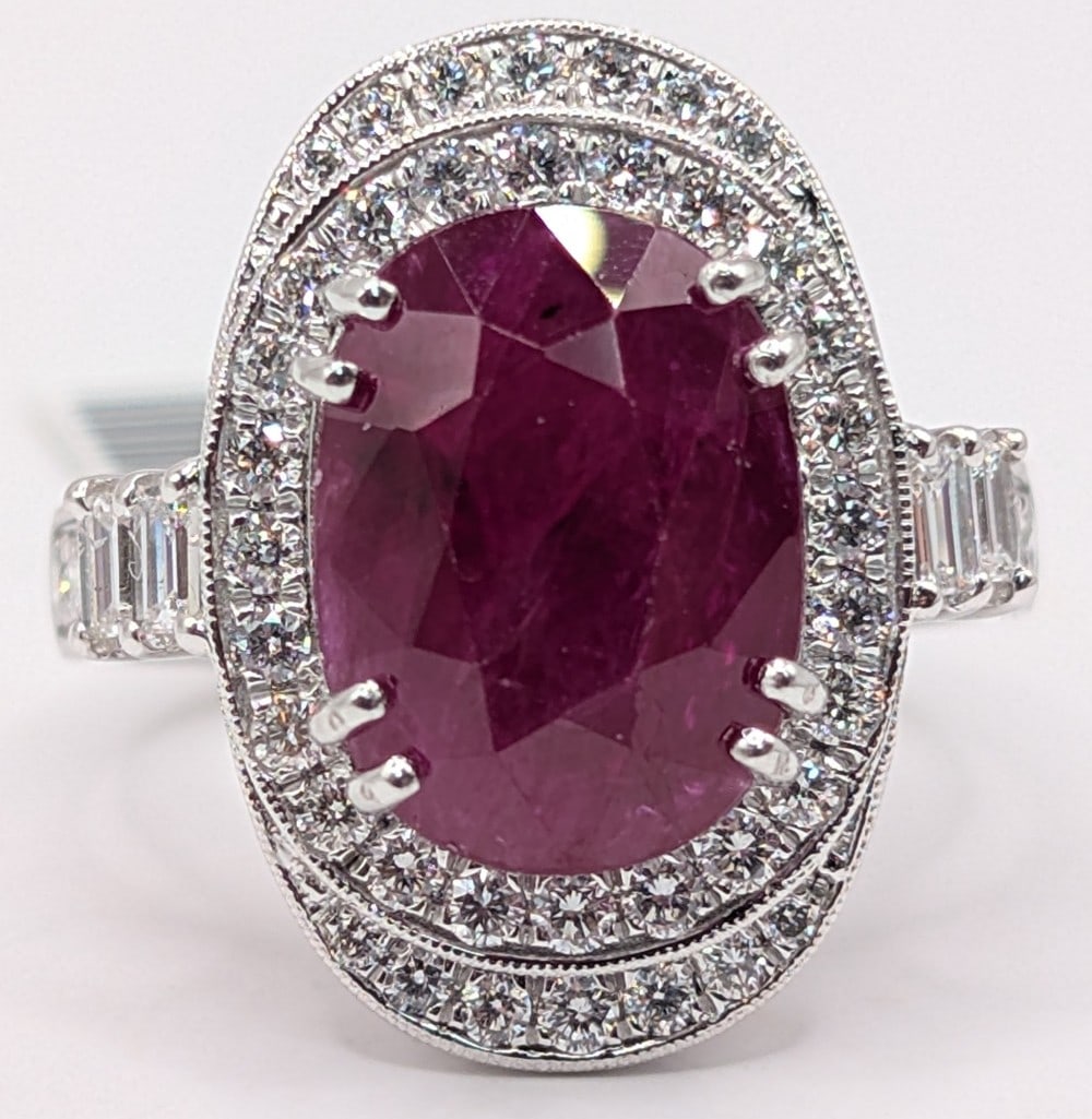 Platinum Oscar Friedman Ruby & Diamond Ring: Platinum designer Oscar Friedman ring with 6.74 CT oval Ruby and (48) baguette and round cut diamonds totaling 0.94 CTS. Ring is size 6.5 and weighs 11.1 grams. Ring comes with an AIGL appraisal