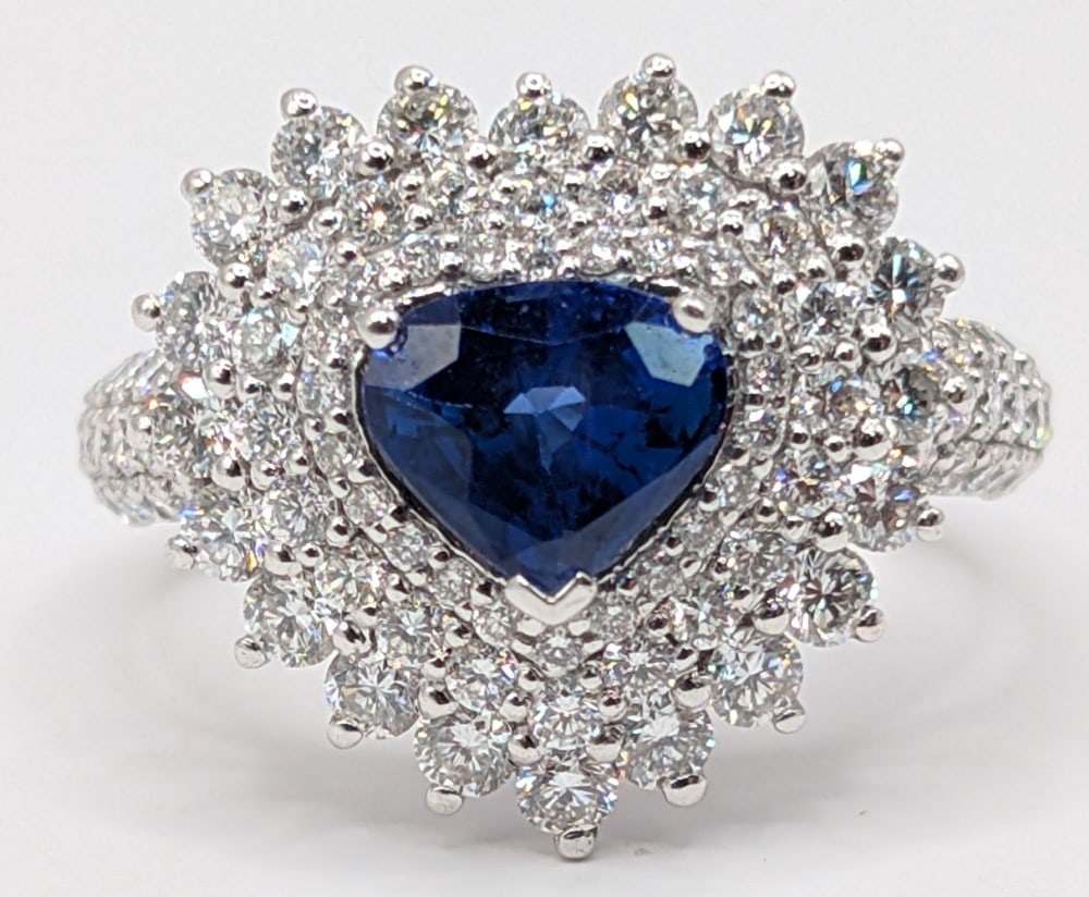Platinum Blue Sapphire & Diamond Ring: Platinum ring with 1.27 CT pear brilliant cut blue sapphire corundum and (96) round brilliant cut diamonds totaling 1.52 CTS. Ring is size 7 and weighs 7.3 grams. Ring comes with a Gemassure