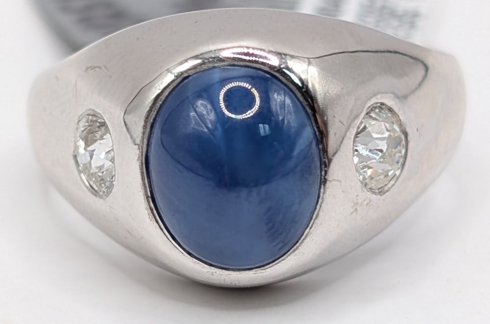 14K Gold 3.10 Carat Star Sapphire & .50 Carat Diamond Ring: 14K White Gold ring with oval cabochon 3.10 carat Star Sapphire and two old European cut natural diamonds with a total carat weight of .50. the two diamonds have a color grade of F and a clarity grade