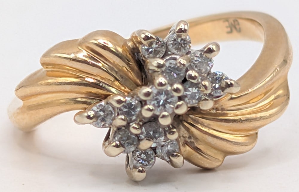 14K Gold Diamond Cluster Ring: 14K yellow gold ring with 13 diamonds. Ring is size 4.5 and weighs 3.7 grams.