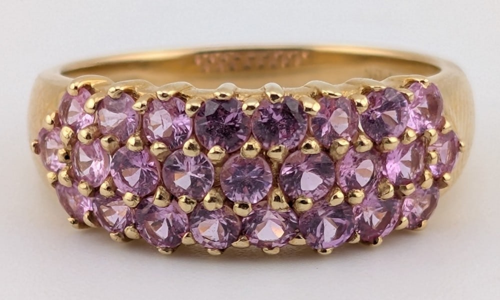 14K Gold Triple-Row Pink Sapphire Ring: 14K yellow gold ring with three rows of round cut pave set pink sapphires. Ring is size 8 and weighs 4.2 grams.