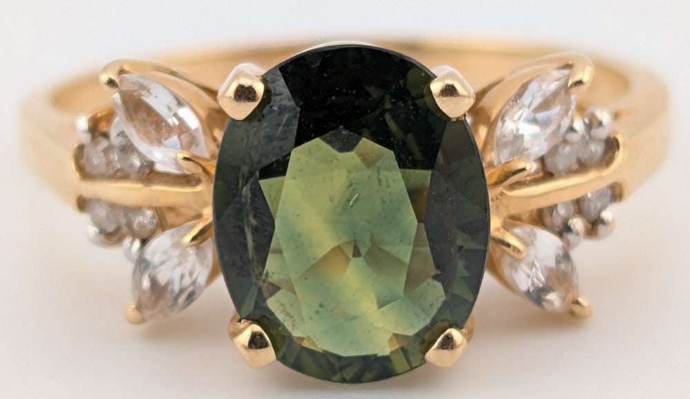 14K Green Sapphire & Diamond Ring: 14K yellow gold ring with oval cut olive green sapphire and diamond accents. Ring is size 8 and weighs 3.6 grams.