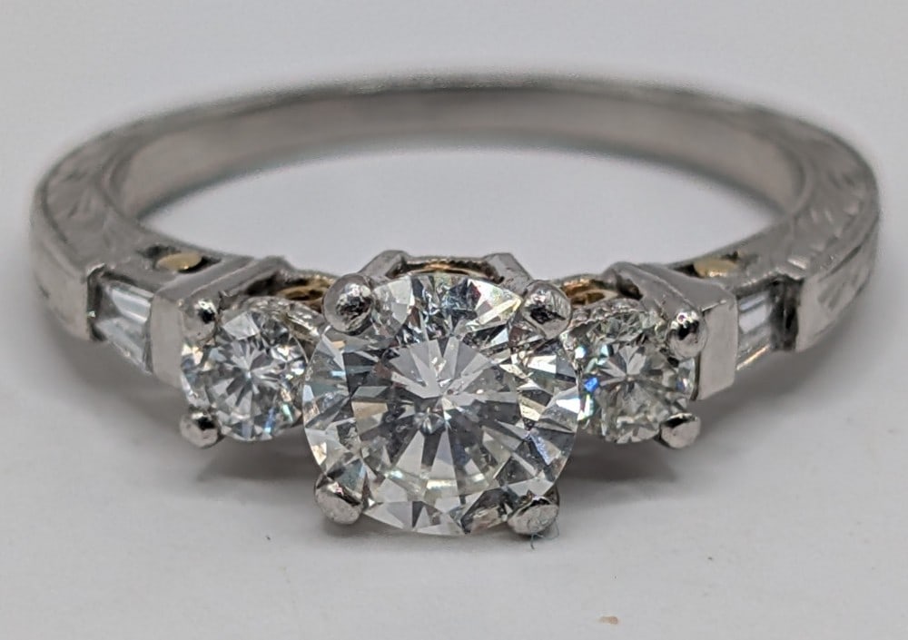 18K Tacori 3 Stone Diamond Engagement Ring: 18K Tacori designer white and yellow gold engagement ring with 3 round cut diamonds and two baguette diamonds. Middle diamond is approximately 0.75 CT. Ring appraises for $6,900. Size 6.25 and weighs