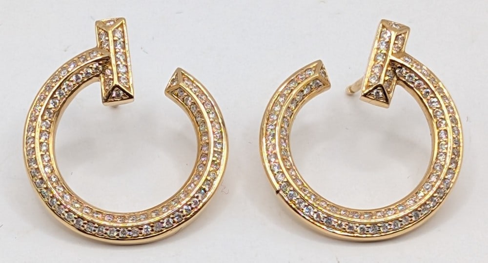 18K Tiffany & Co. "T" Open Hoop Diamond Earrings: Tiffany T is inspired by an archival bracelet from 1975, T is an homage to the House?s iconic motif and the spirit of New York, which founder Charles Lewis Tiffany regarded as the place of promise and