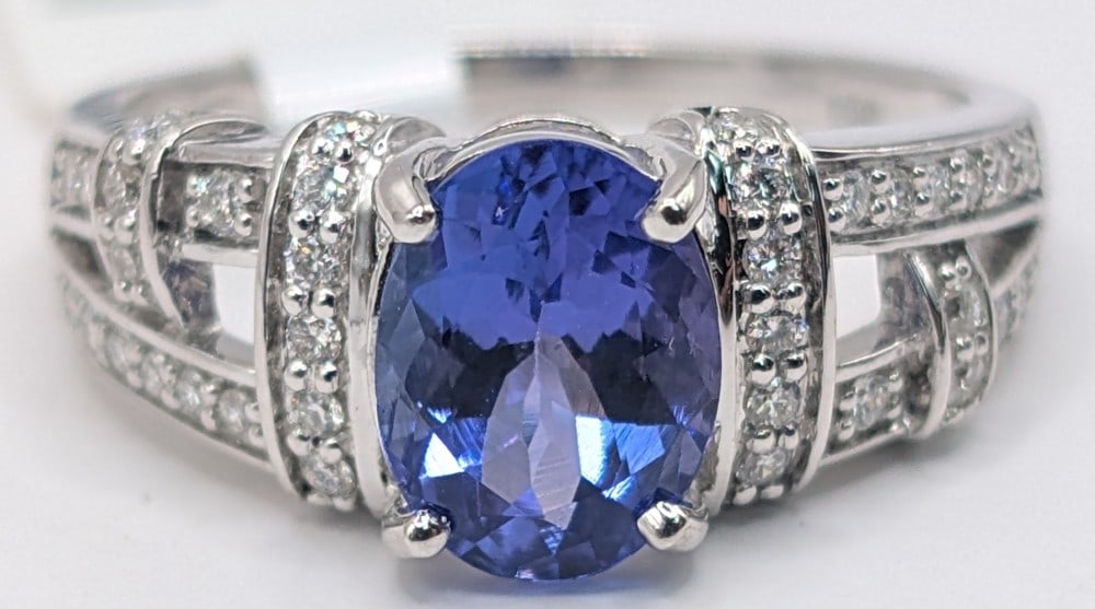 18K Tanzanite & Diamond Ring: 18K white gold ring with oval 1.38 CT Tanzanite and 0.23 cts diamond accents. Ring is size 6.5 and weighs 4.6 grams. Ring comes with an AIGL appraisal report with an estimated retail replacement value