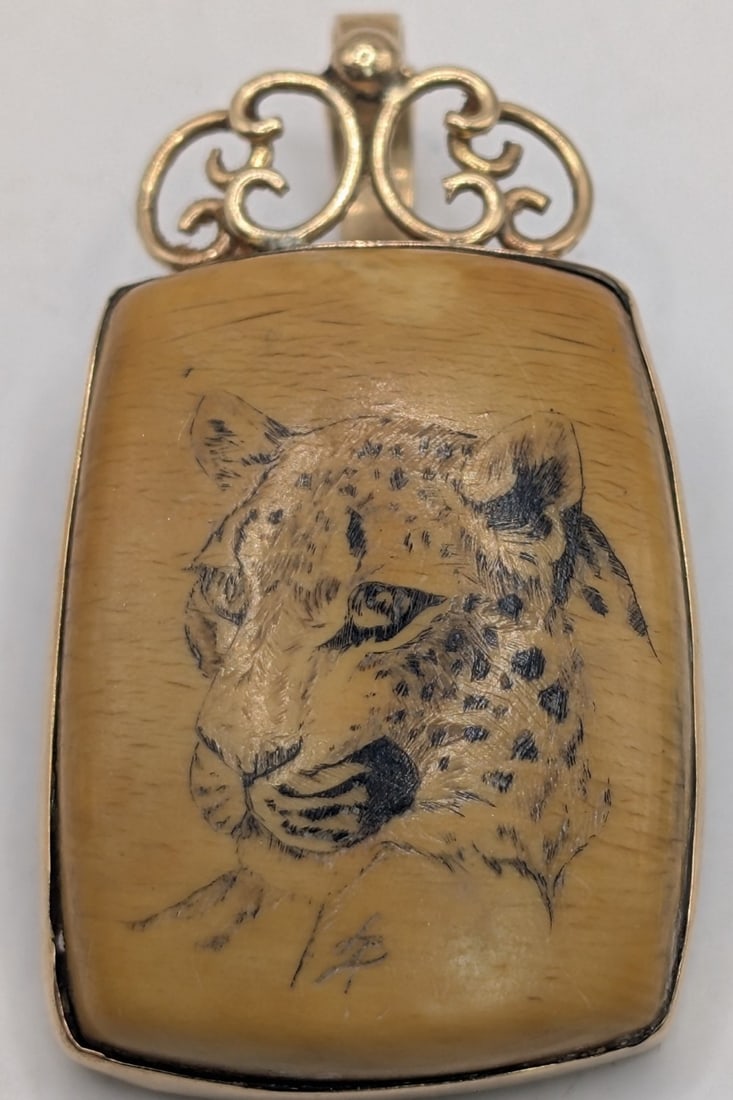 14K Gold Scrimshaw Cheetah Pendant: 14K yellow gold scrimshaw cheetah pendant. Measures 1.75" and weighs 10.3 grams.