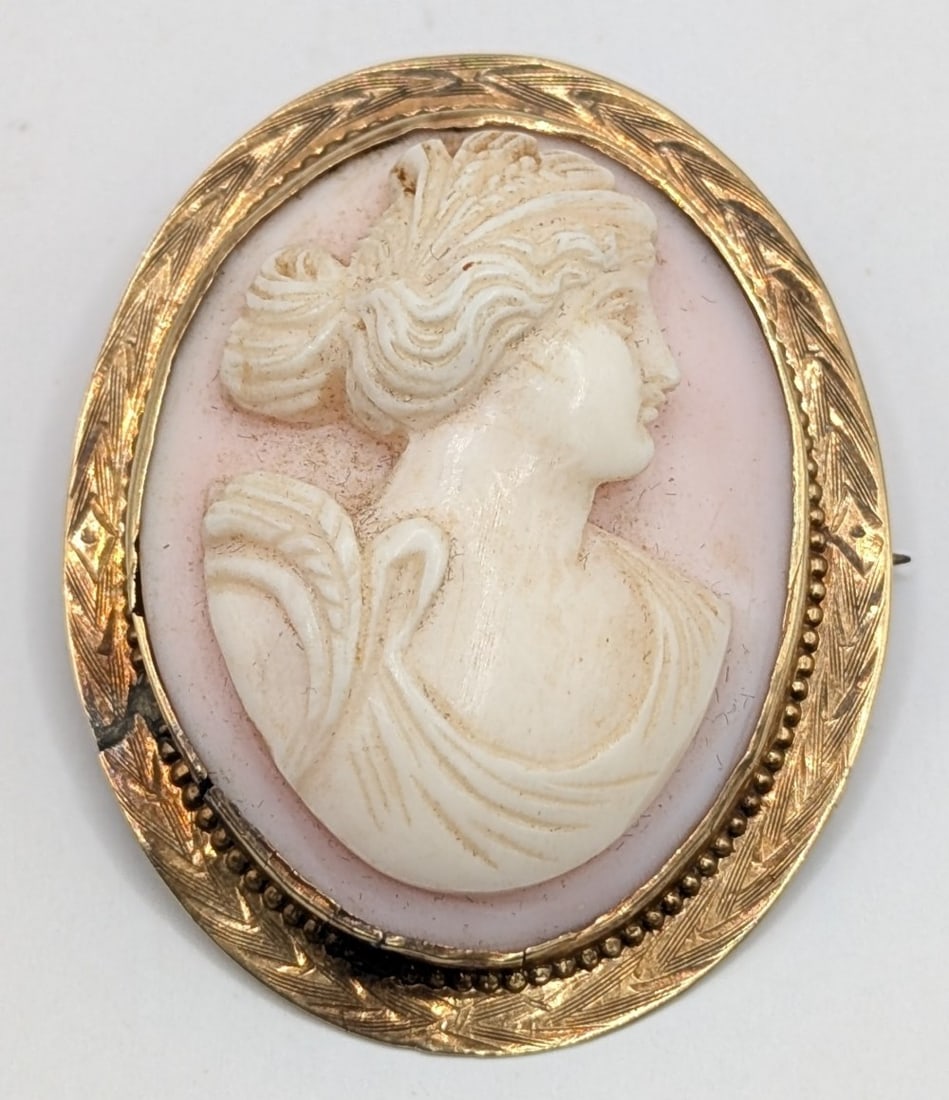 Vintage 10K Gold Cameo Brooch: Vintage 10K yellow gold framed carved shell cameo brooch. Measures 2" by 1.5" and weighs 7.1 grams.