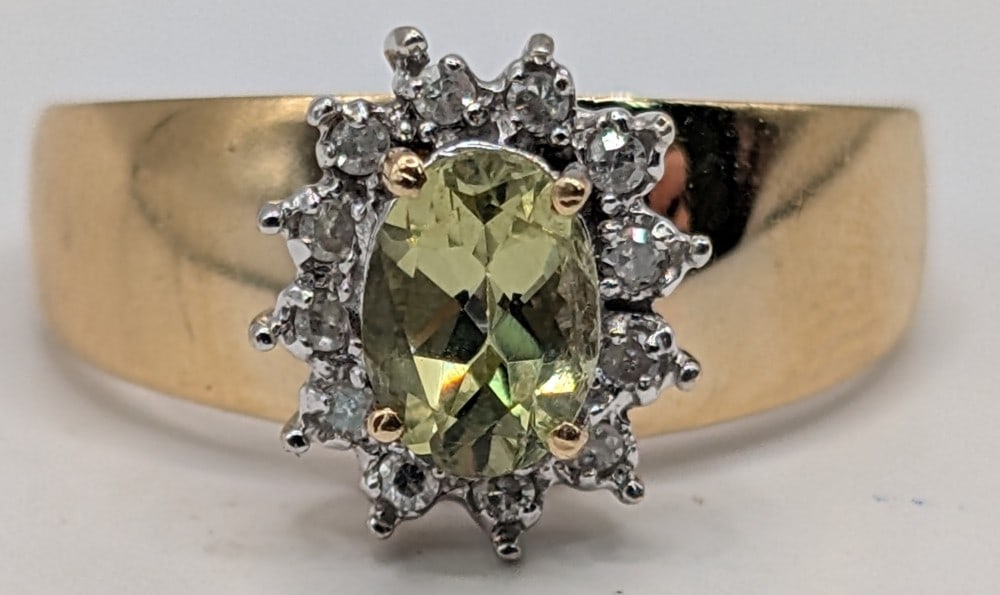 14K Gold Peridot & Diamond Halo Ring: 14K yellow gold wide band ring with oval cut green Peridot and round cut diamond halo. Ring is size 7 and weighs 4.8 grams.