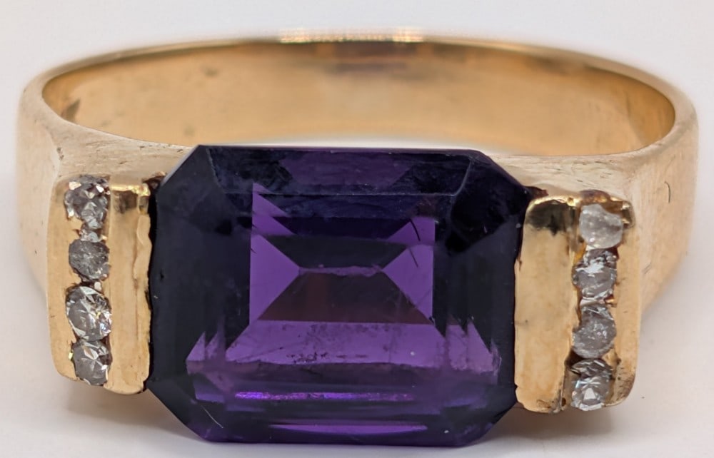 14K Gold Amethyst & Diamond Ring: 14K yellow gold ring with emerald cut purple amethyst and channel set diamonds. Ring is size 5 and weighs 4.3 grams.