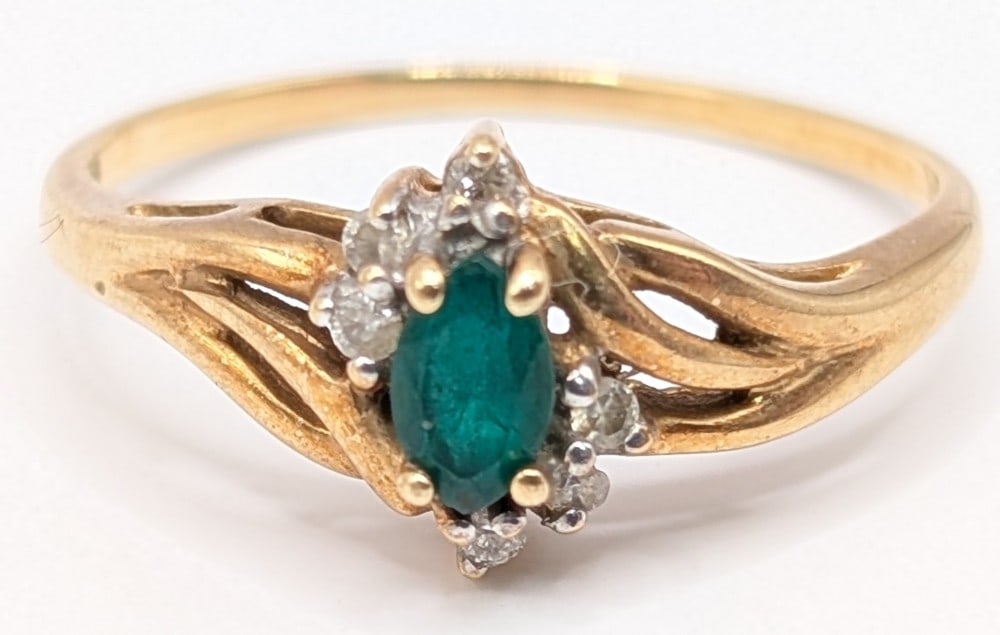 10K Gold Emerald & Diamond Ring: 10k yellow gold ring with marquis cut green emerald and diamond accents. Ring is size 6.5 and weighs 1.8 grams.