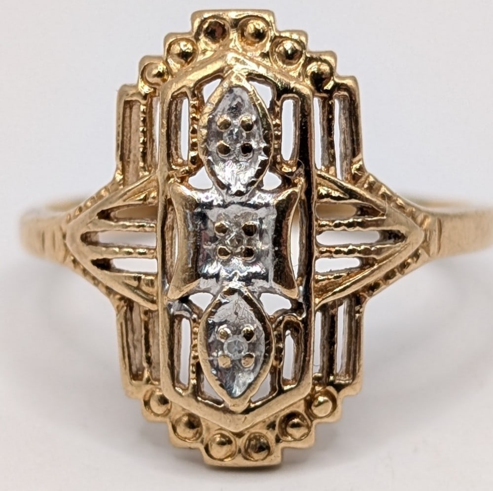 10K Gold Art Deco Filigree Diamond Shield Ring: Vintage 10K yellow gold filigree ring with 3 diamond chips. Ring is size 6 and weighs 2.5 grams.