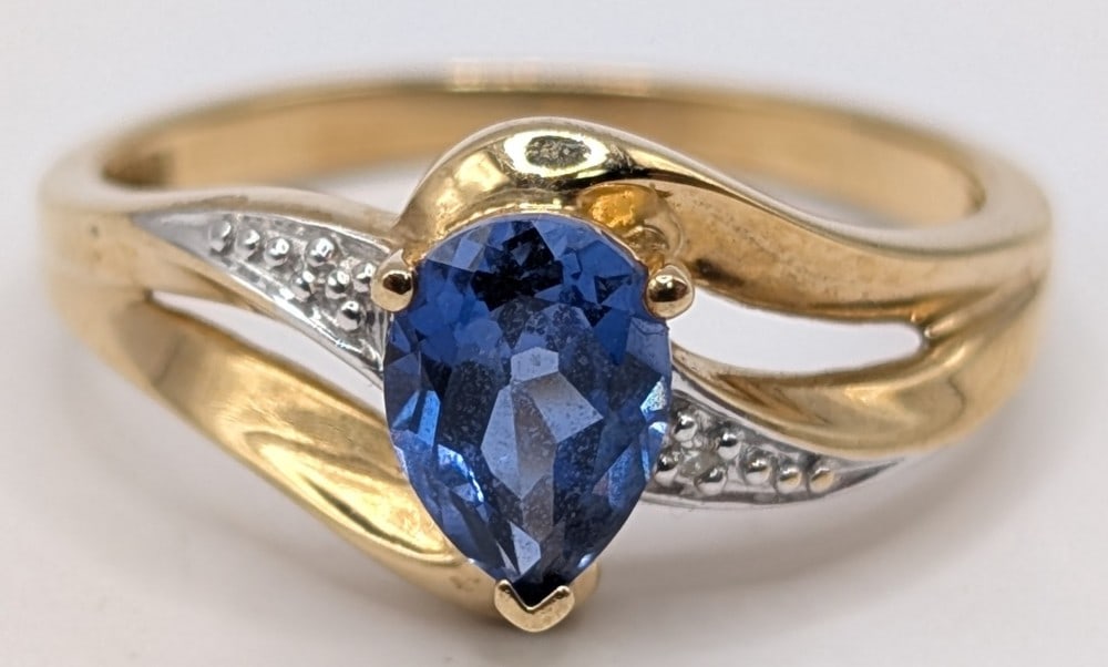 10K Gold Tanzanite & Diamond Ring: 10K yellow gold ring with pear cut Tanzanite and diamond accents. Ring is size 6.5 and weighs 1.9 grams.