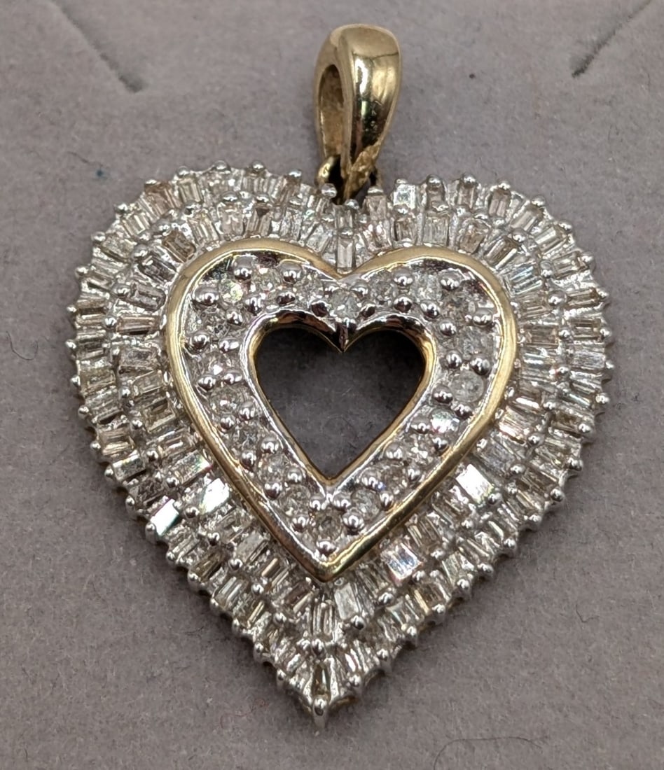 10K Gold Diamond Heart Pendant: 10K yellow gold cookie cutter heart pendant with round cut and baguette diamonds. Pendant weighs 3.9 grams.
