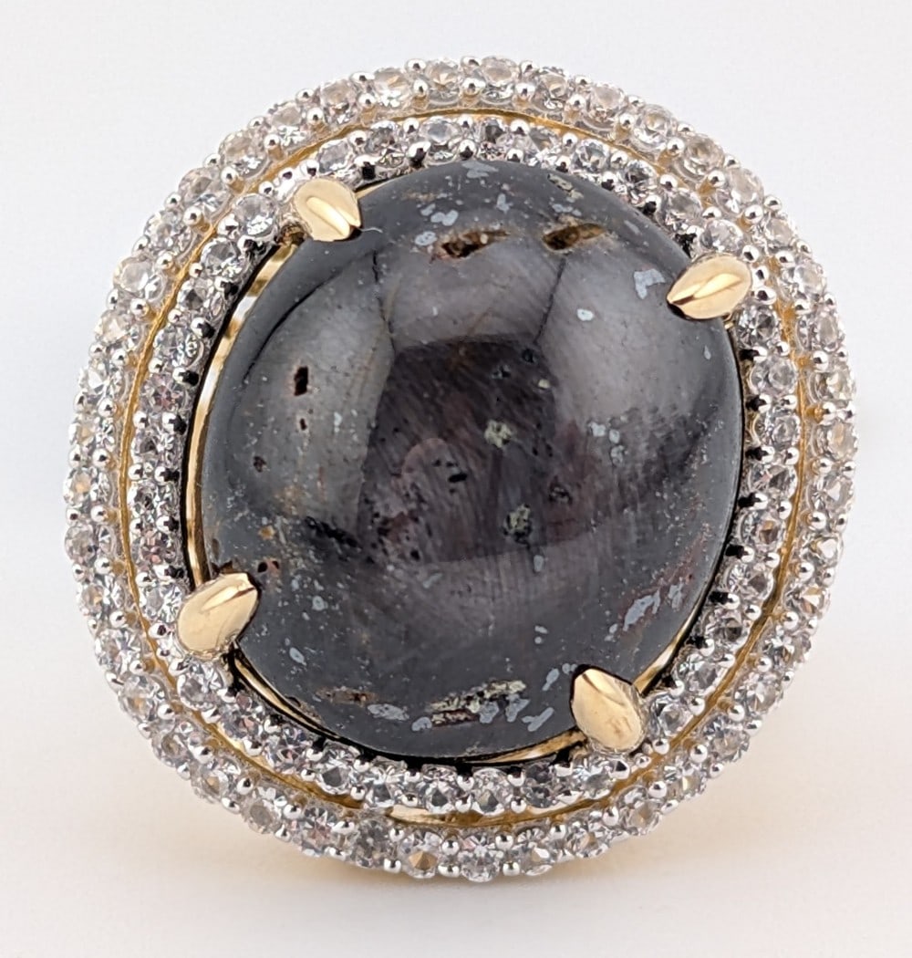 Sterling 29.23 CT Star Ruby & White Sapphire Halo Ring: Sterling silver star Ruby halo ring. The Ruby is 29.23 CT and the round cut white sapphire double halo has a ctw of 1.22. The ring comes with an AIG Gem laboratory report with a replacement appraisal