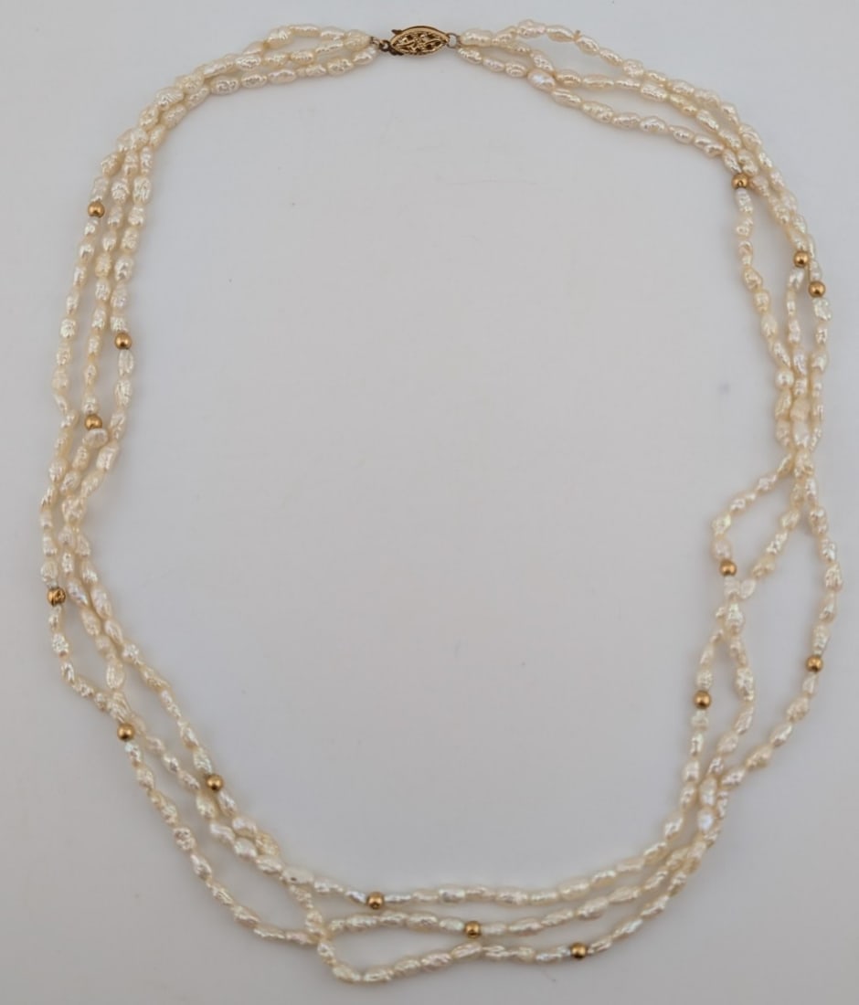 14K Gold Clasp 3 Strand Freshwater Pearl Necklace: 14K yellow gold clasp 3 Strand freshwater pearl necklace. Necklace has 15 gold beads and measures 18"