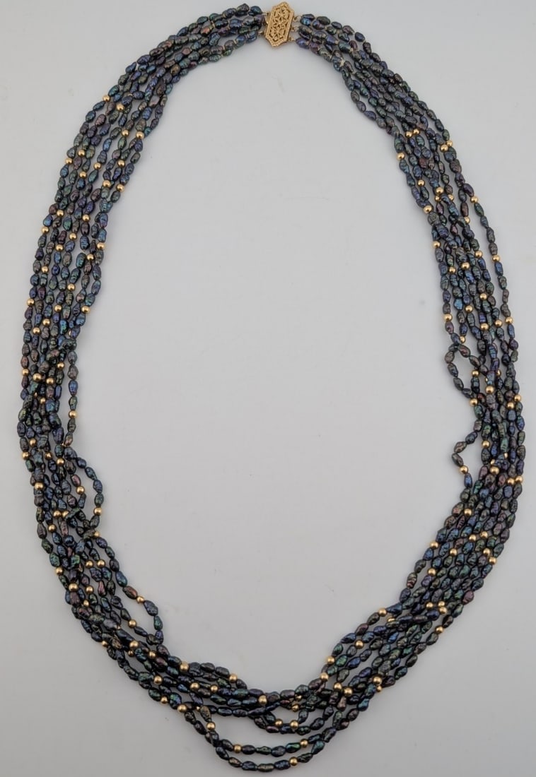 14K Gold Clasp 7 Strand Iridescent Japanese Rice Pearl Necklace: 14K yellow gold clasp and beads 7 strand necklace with iridescent Japanese rice pearls. Measures 22"