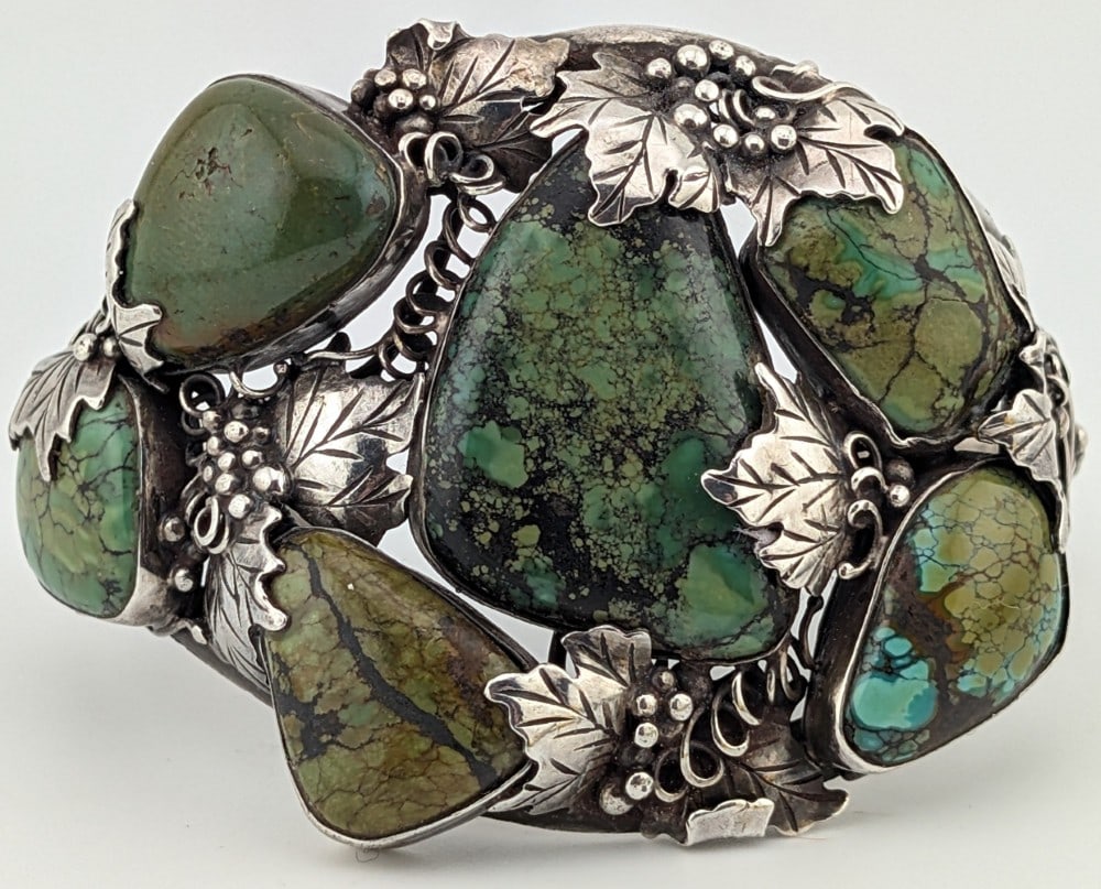 Vintage Sterling Navajo Grape Vine Green Turquoise Cuff Bracelet: Large vintage sterling silver Navajo cuff with green turquoise stones and grapevine design. Cuff measures 2" at widest point and weighs 73 grams.