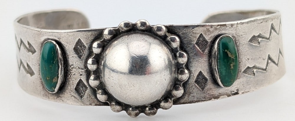 Vintage Sterling Native American Green Turquoise Cuff Bracelet: Vintage sterling silver Native American cuff with two oval cabochon green turquoise stones. Cuff weighs 23 grams.