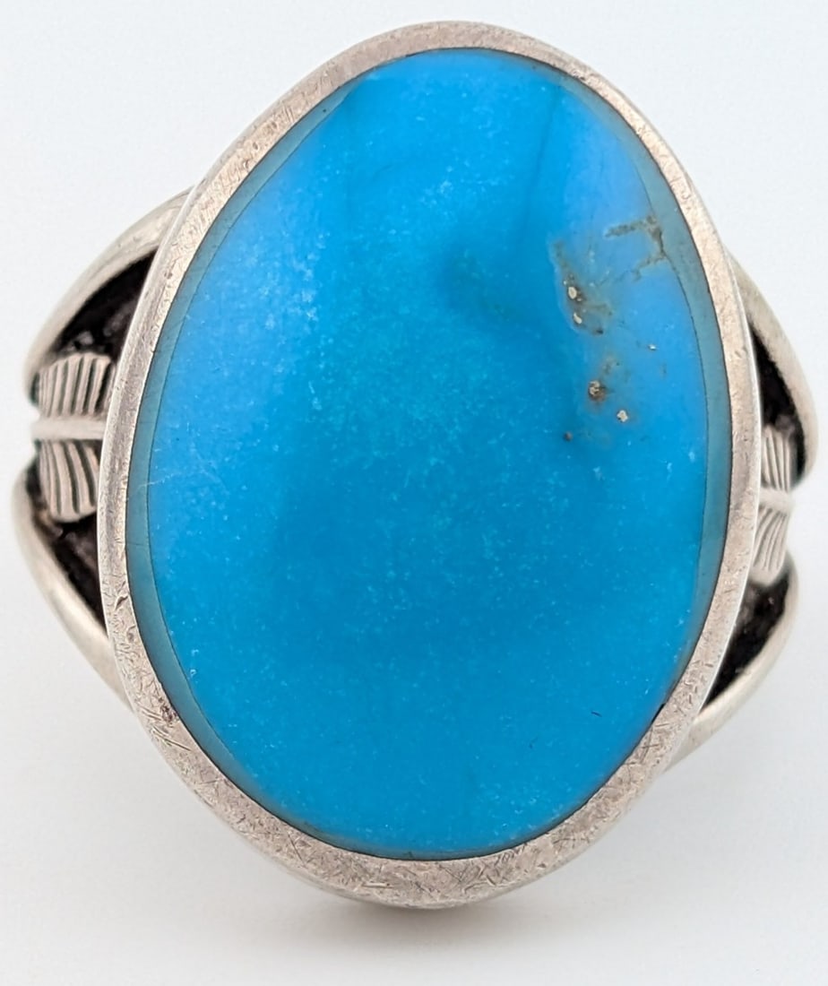 Vintage Sterling Navajo Oval Turquoise Ring: Vintage sterling silver Navajo Signed RO with an anvil makers mark ring with oval cabochon bright turquoise stone. Ring is size 11 and weighs 18.7 grams.