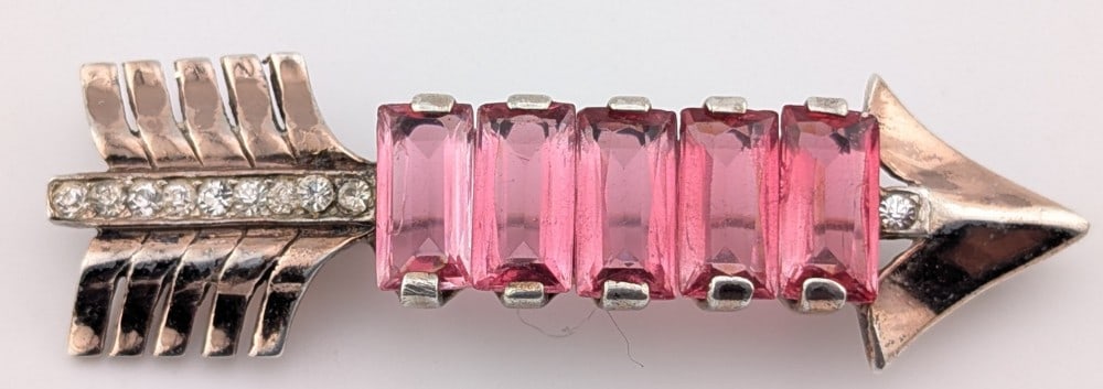 Vintage Sterling Reja Ruby & Sapphire Arrow Brooch: Vintage sterling silver designer Reja arrow brooch with 5 emerald cut rubies and round cut white sapphire accents. Brooch measures 2.5" long and weighs 17.5 grams.