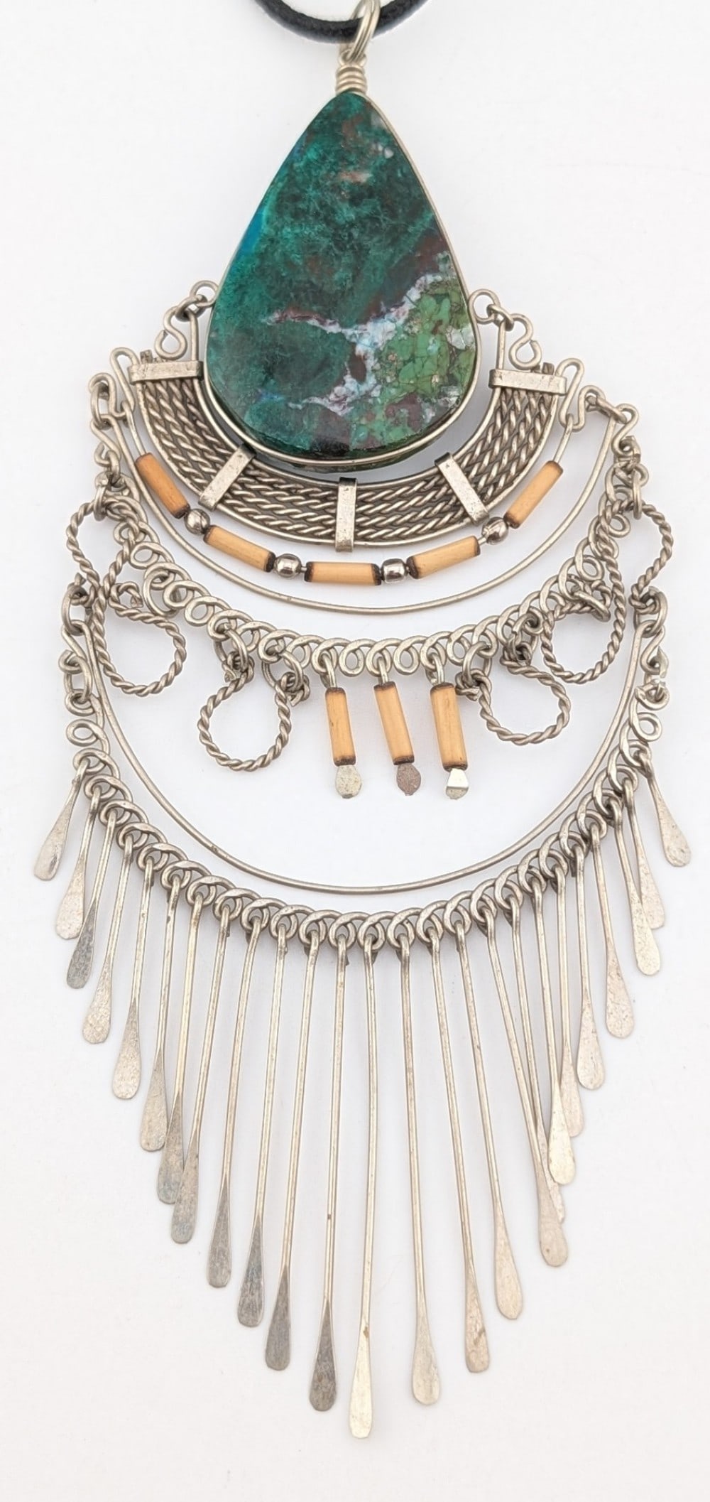 Vintage Peruvian Sterling Wirework Turquoise Bib Necklace: Vintage sterling silver Peruvian wirework bib necklace with large pear cut turquoise stone. Pendant is on a chord. Pendant weighs 28 grams.