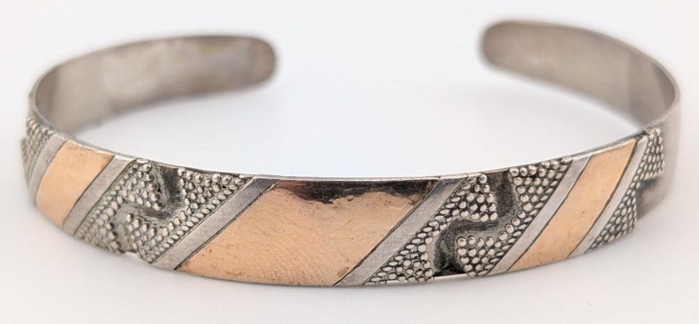Vintage Navajo Mixed-Metal Sterling Silver & Gold-Fill Wave Motif Cuff Bracelet: Handcrafted Navajo artisan cuff bracelet featuring a sophisticated mixed metal design. Cuff weighs 15.2 grams.