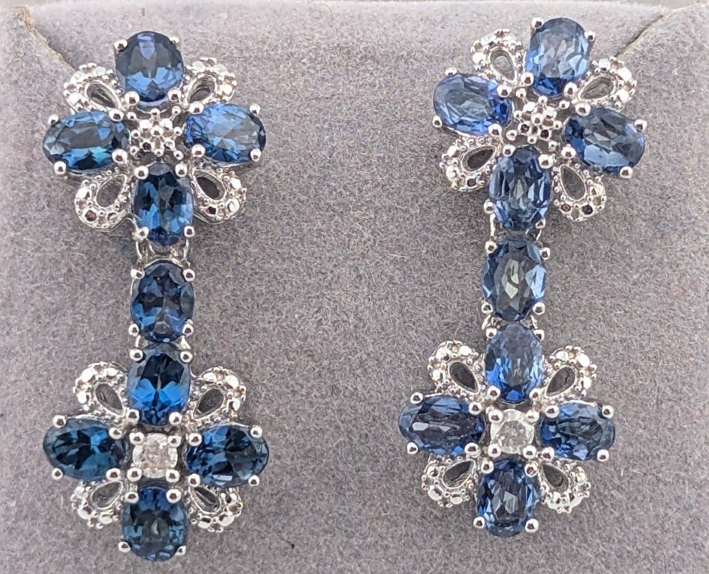 Sterling 2.89 ctw Oval Tanzanite & Diamond Dangle Earrings: Sterling silver dangle earrings with oval Tanzanite and round cut diamonds. The Tanzanite is 2.89 ctw and the diamonds are .08 ctw. Total weight is 4.8 grams. Earrings come with a GGA registered appra