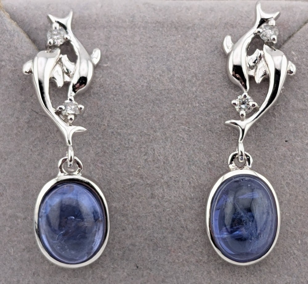 Sterling 3.41 ctw Tanzanite & Diamond Dolphin Dangle Earrings: Sterling silver dolphin dangle earrings with oval cabochon Tanzanite and round cut diamonds. The Tanzanite are 3.4 ctw and the diamonds are .11 ctw. Total weight is 2.9 grams. Earrings come with a GGA