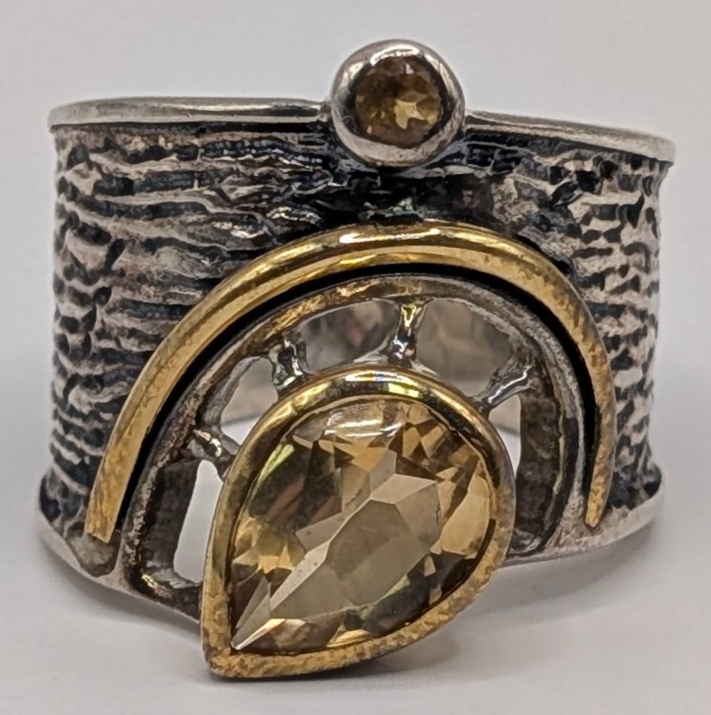 Sterling & 14K Gold Plate Arya Double Citrine Wide Band Ring: Sterling silver and 14K Gold plate accent wide band designer Arya ring. Ring has a round cut citrine and a main stone pear cut citrine. Band measures 3/4" at widest point. Ring is size 7 and weighs 9.