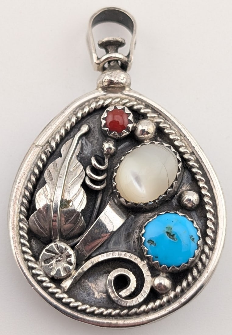 Sterling Native American Keith Henry Double Sided Pendant: Vintage sterling silver Native American artist signed Keith Henry teardrop double sided pendant with turquoise, mother of pearl, coral and Kokopelli. Pendant measures 1.5" by 1" and weighs 10.2 grams.