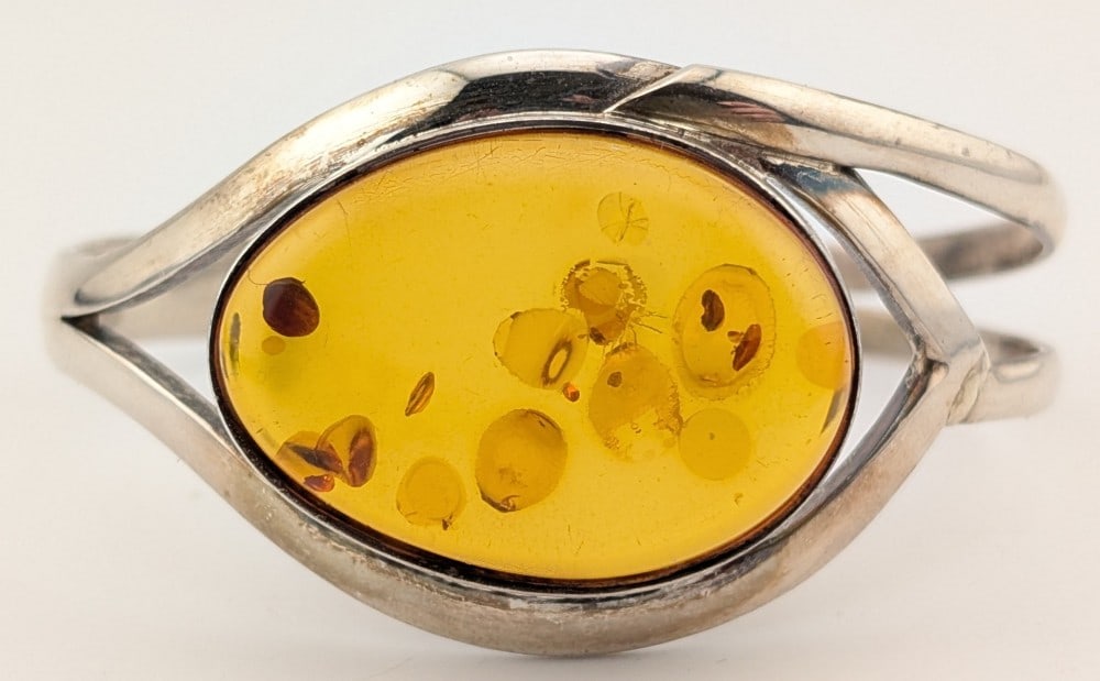 Vintage Sterling Amber Cuff Bracelet: Vintage Sterling silver cuff bracelet with large amber stone. Bracelet weighs 36 grams.