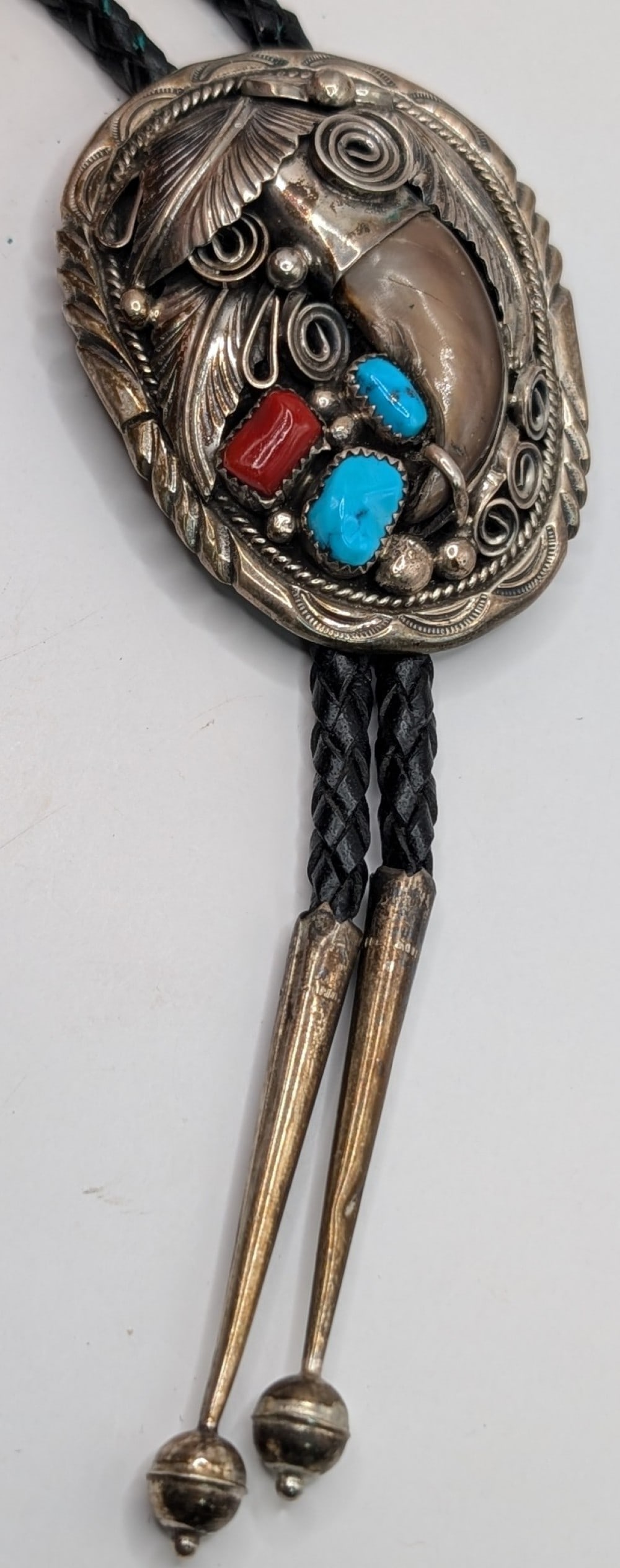 Sterling Navajo M. Thomas Jr. Turquoise & Coral Bear Claw Bolo Tie: Vintage Navajo artist M. Thomas Jr signed sterling silver bolo tie with turquoise, coral and genuine bear claw. Measures 3.5" and weighs 65.1 grams.