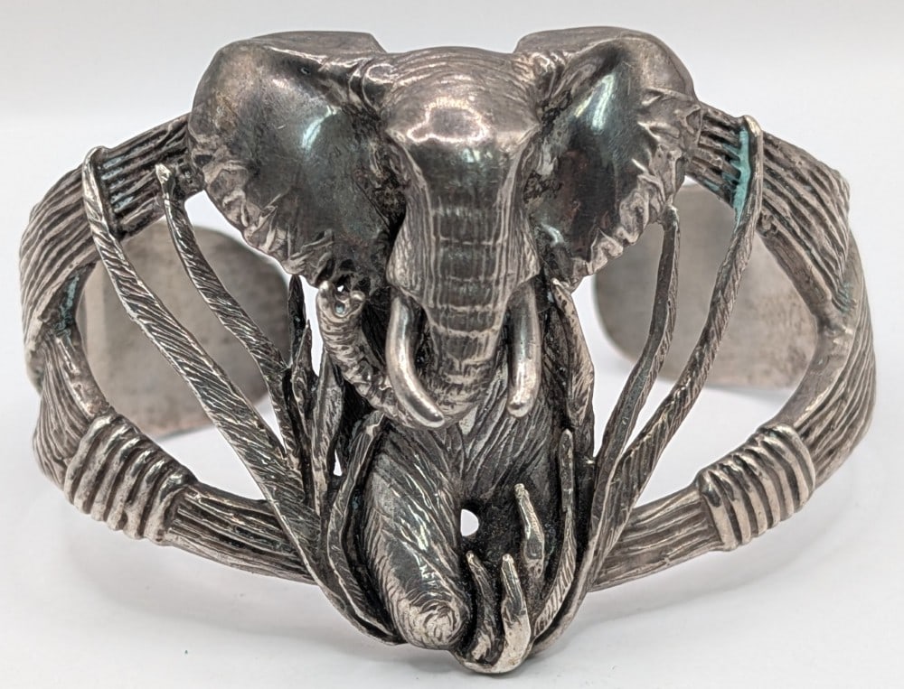 Handcrafted Sterling Silver African Elephant Cuff Bracelet: Sterling silver cuff bracelet featuring a? three-dimensional elephant, this piece captures the intricate detail of the African Elephant, from the texture of its skin to its sweeping tusks. Bracelet we