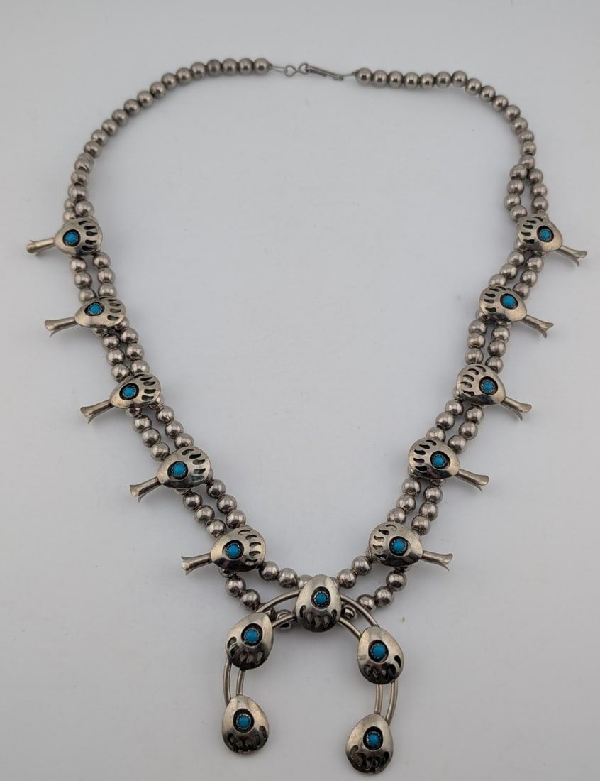 Vintage Sterling Squash Blossom Bear Print Necklace: Vintage Sterling silver squash blossom necklace with bear paw print and turquoise stones. Necklace measures 22" and weighs 88.3 grams.