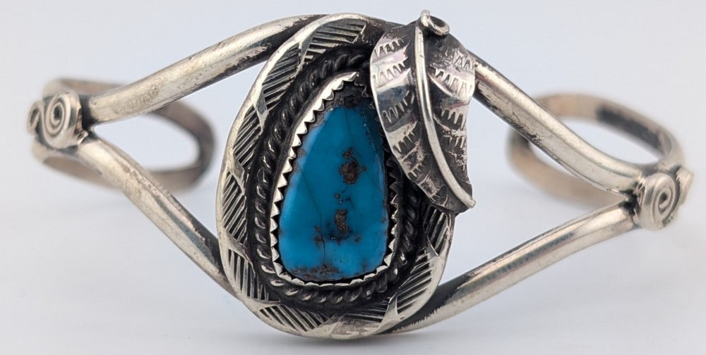 Vintage Sterling Native American Turquoise Cuff Bracelet: Vintage sterling silver cuff hand made by unknown native American artist with large turquoise stone. Cuff weighs 21 grams.