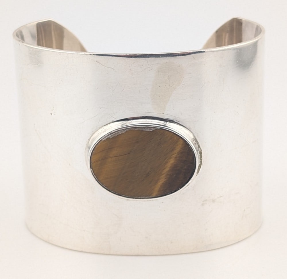 Sterling Wide Cuff Modernist Tigers Eye Cuff Bracelet: Sterling silver neide cuff modernist bracelet with oval tigers eye. Cuff is 2" wide and weighs 78 grams.