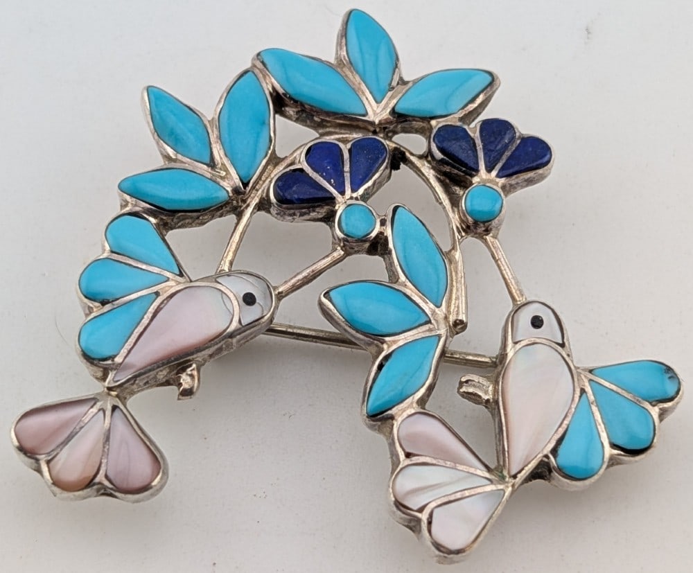 Sterling Zuni Ellen Quandelacy Hummingbird Brooch/Pendant: Beautiful sterling silver Zuni Artist Ellen Quandelacy hummingbird brooch/pendant with inlaid lapis lazuli, turquoise and mother of pearl. Brooch measures 1.5" and weighs 7.4 grams.