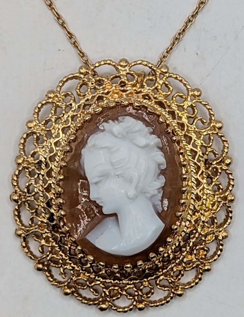 14K Gold Cameo Shell Pendant Necklace: 14K yellow gold shell cameo pendant on 18" 14k chain. Total weight is 7.6 grams.